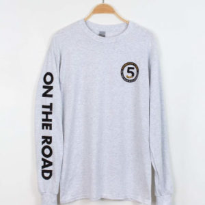 long sleeve gray t-shirt that says "on the road" on the sleeve and has the On the Road Collaborative 5th Anniversary logo on the front