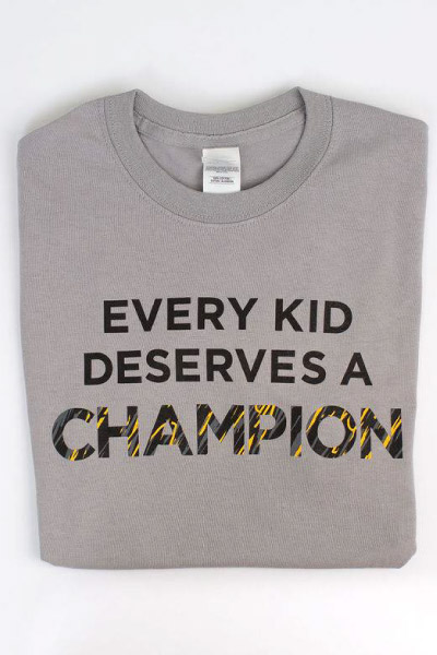 gray short sleeve t-shirt that says "every kid deserves a champion"