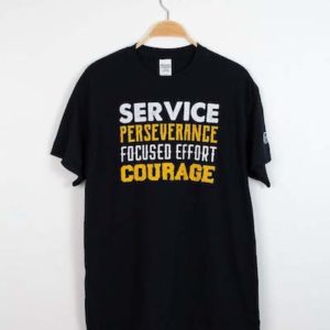 Black t-shirt that reads "service perseverance focused effort courage" in on the road branding material