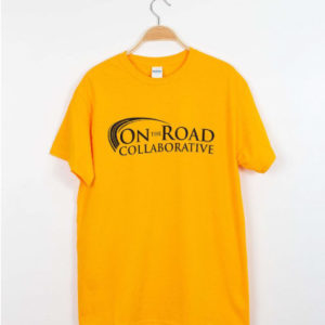 Yellow t-shirt with the "On the Road Collaborative" logo in black