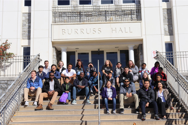 group of on the road youth pose for a photo outside of JMU's Burrus Hall